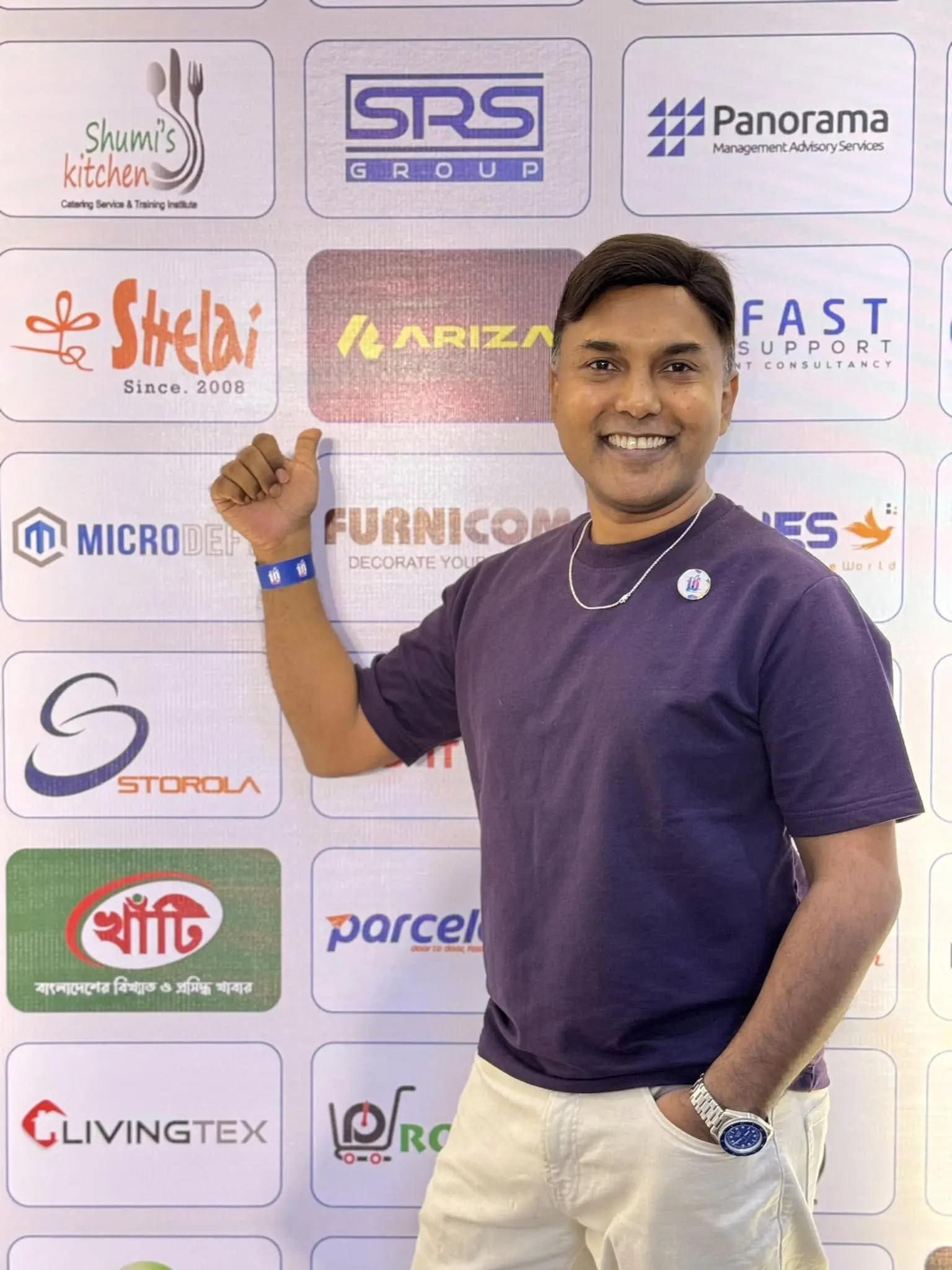 Arif Chowdhury standing in front of brand logos